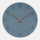 Round wall clock with blue face and bronze hands on a white background