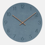 Round wall clock with blue face and bronze hands on a white background