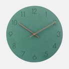 Green wall clock with brown hands on a light gray background