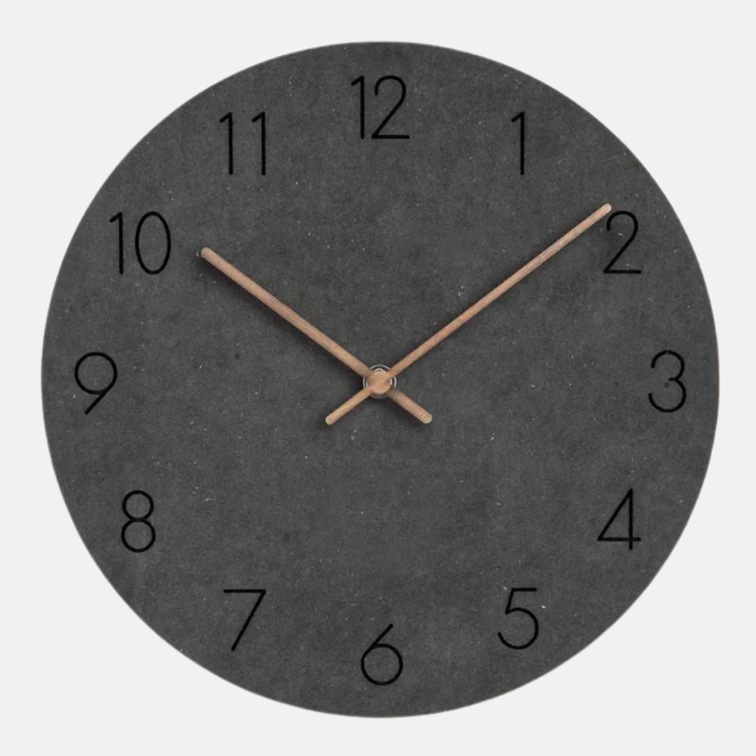 Round wall clock with black face and bronze hands on a white background