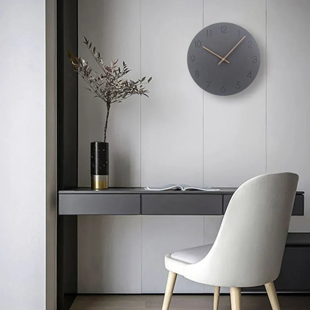 Modern interior with a desk, chair, and decorative elements on a light gray wall.
