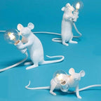 White mouse-shaped lamps with light bulbs on a blue background