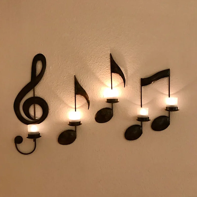 Decorative wall sconces shaped like musical notes on a white wall.