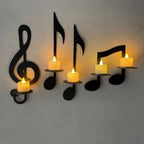 Wall-mounted candle holders shaped like musical notes and a treble clef on a plain background.