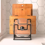 Set of wooden cutting boards with a transparent lazy susan on a tiled kitchen floor.