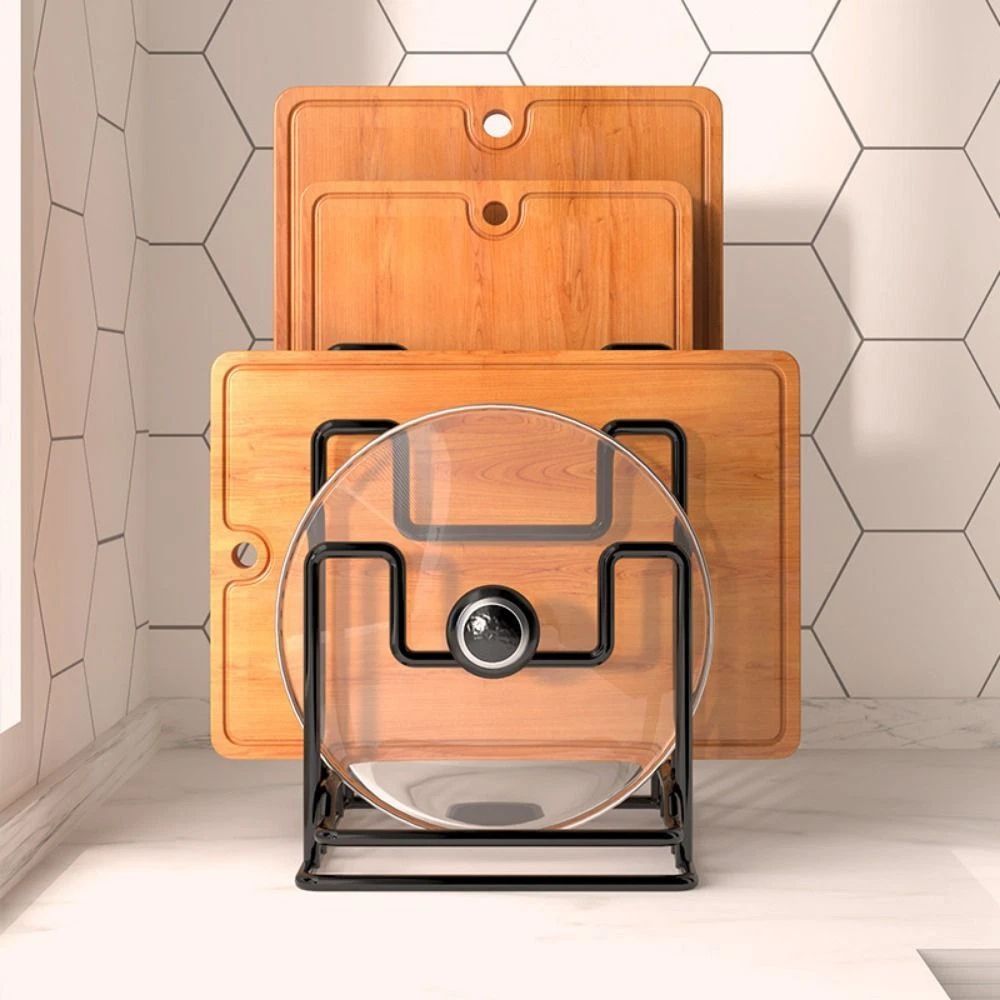 Set of wooden cutting boards with a transparent lazy susan on a tiled kitchen floor.