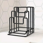 Black metal bottle rack against a white tiled wall