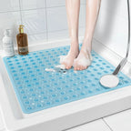 Blue textured bath mat in a shower with a person stepping on it.