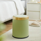 Green cylindrical stool with gold accents in a room setting