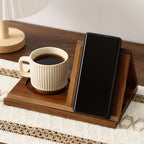 Wooden tray with a cup of coffee and a smartphone on a table.