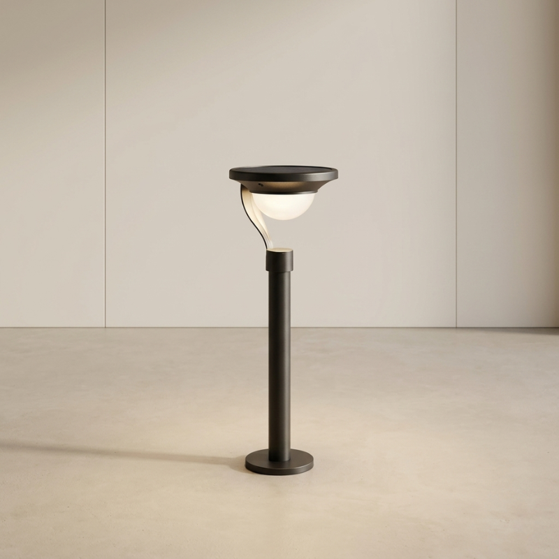 Black outdoor lamp post with a light on a beige background