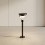 Black outdoor lamp post with a light on a beige background