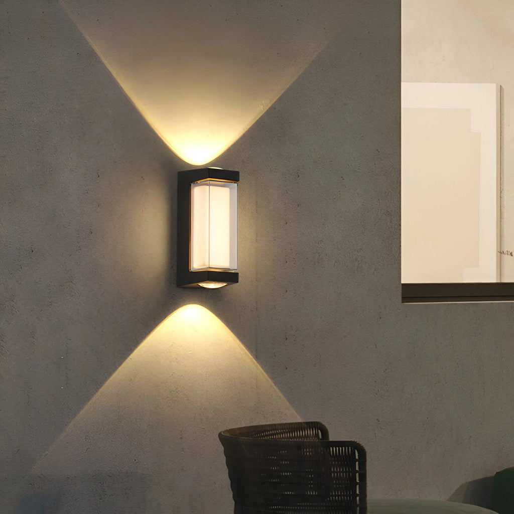 Modern wall-mounted light fixture on a concrete wall with a chair in the foreground.