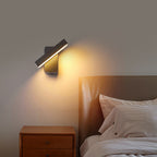 Modern wall sconce lighting above a bed in a bedroom setting.