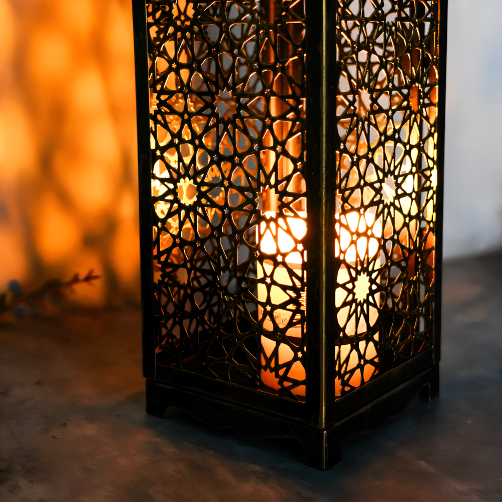 Decorative lantern with intricate patterns and warm light on a blurred background