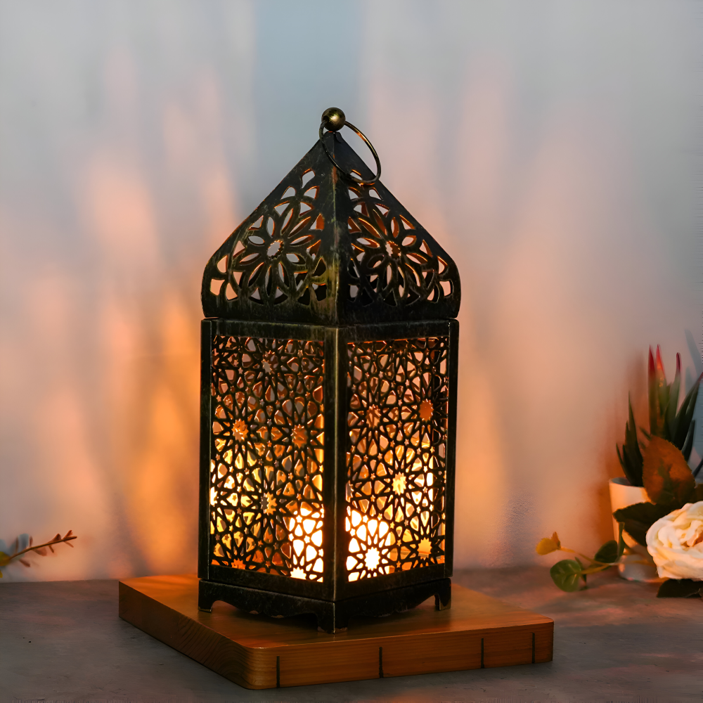 Decorative lantern with intricate patterns on a wooden base, emitting a warm glow against a blurred background.