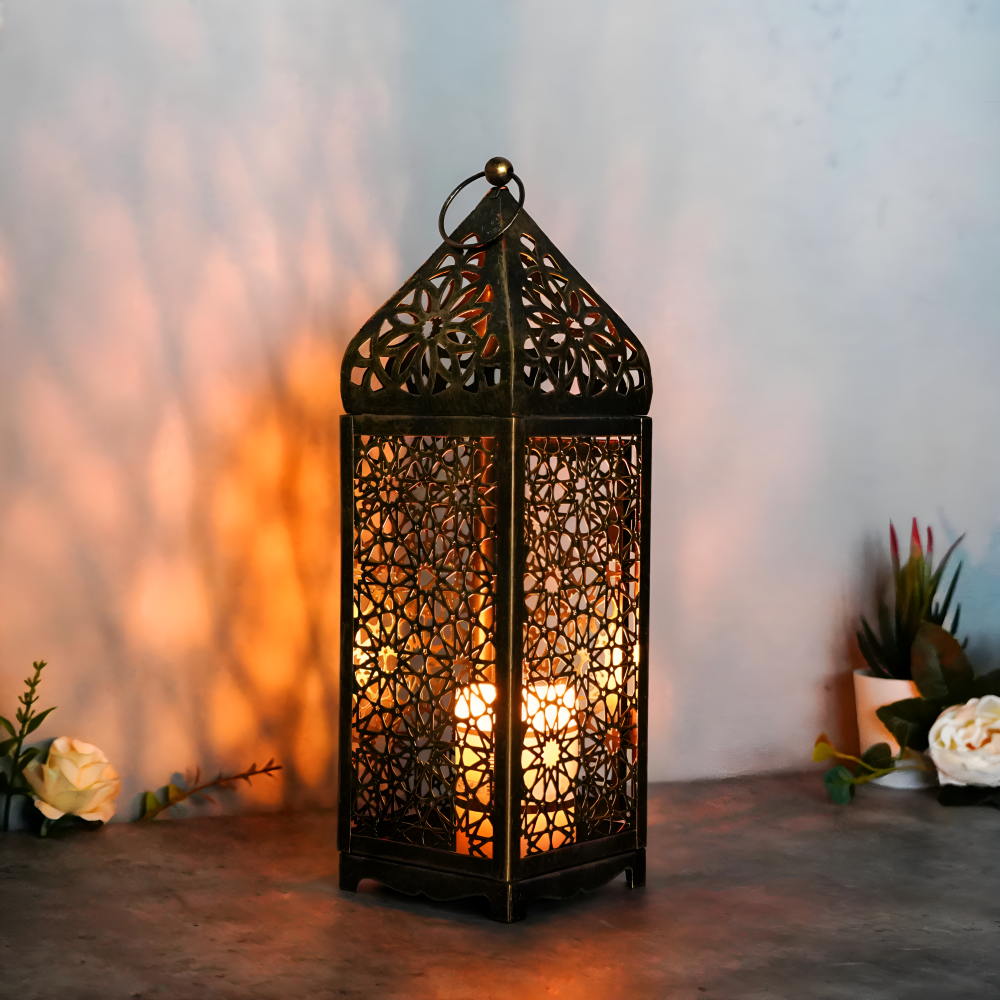 Decorative lantern with intricate patterns, glowing warmly against a soft blurred background.