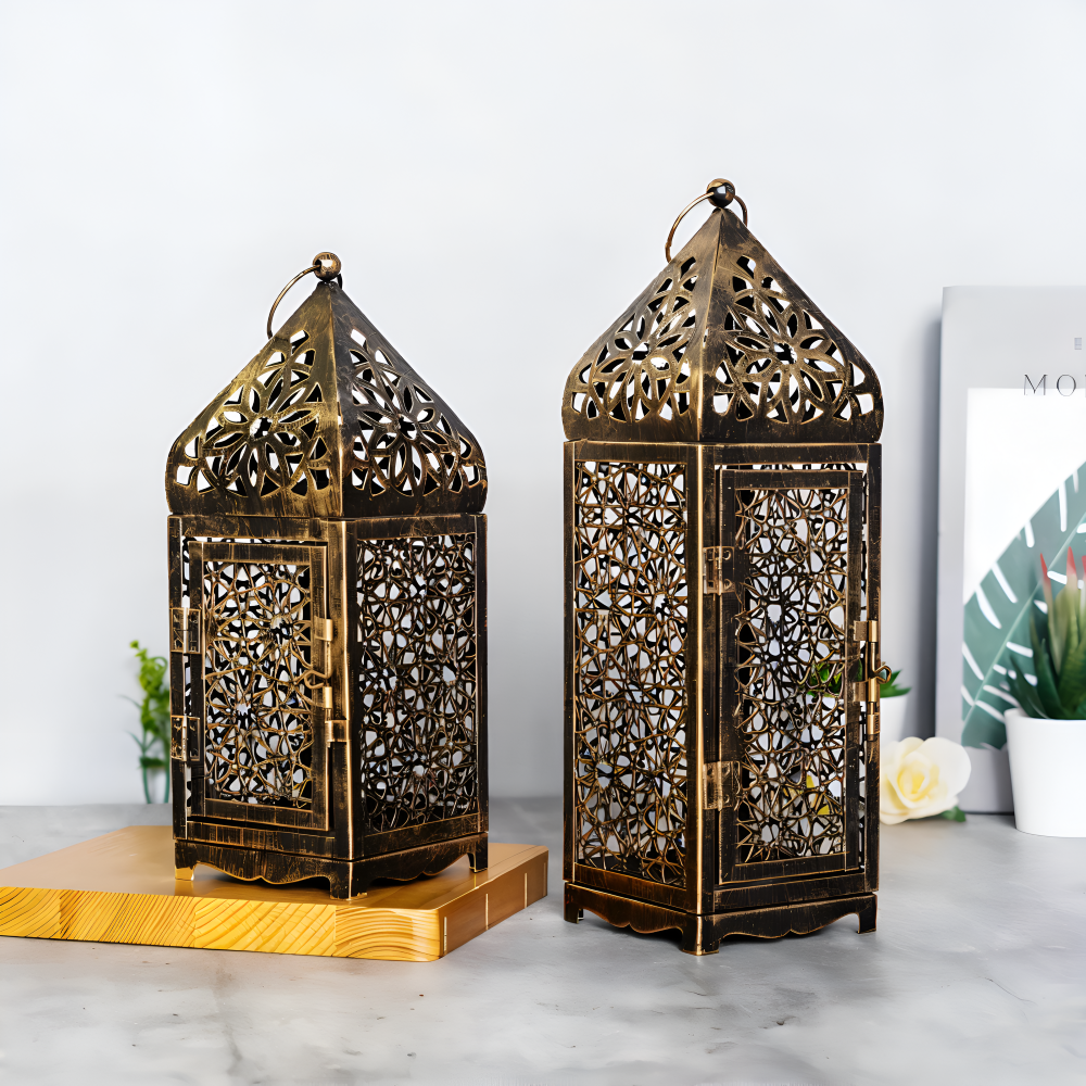 Two ornate brass lanterns on a marble surface with a light background