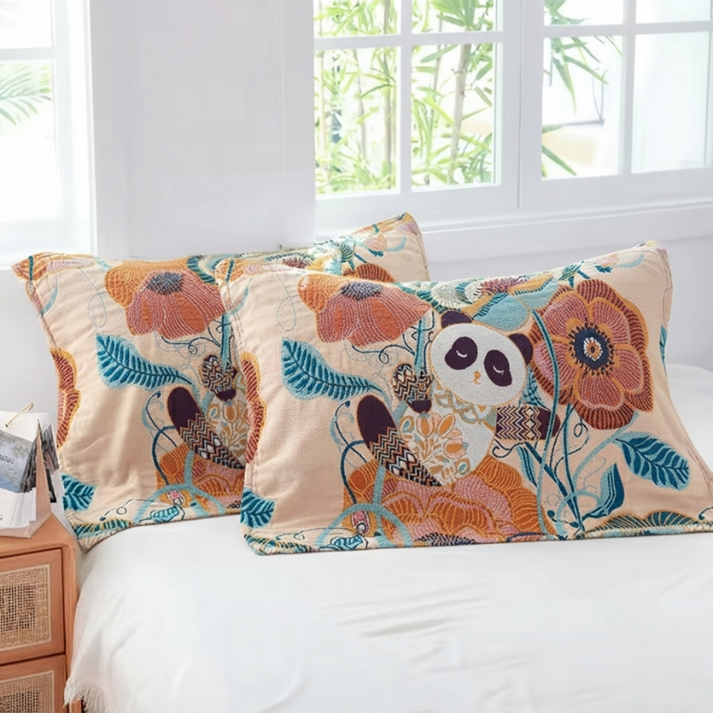 Two decorative pillowcases with a colorful panda and floral pattern, displayed on a white bed in a bright bedroom setting.