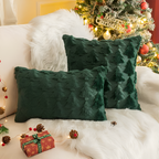 Green textured pillows on a couch with a Christmas tree in the background