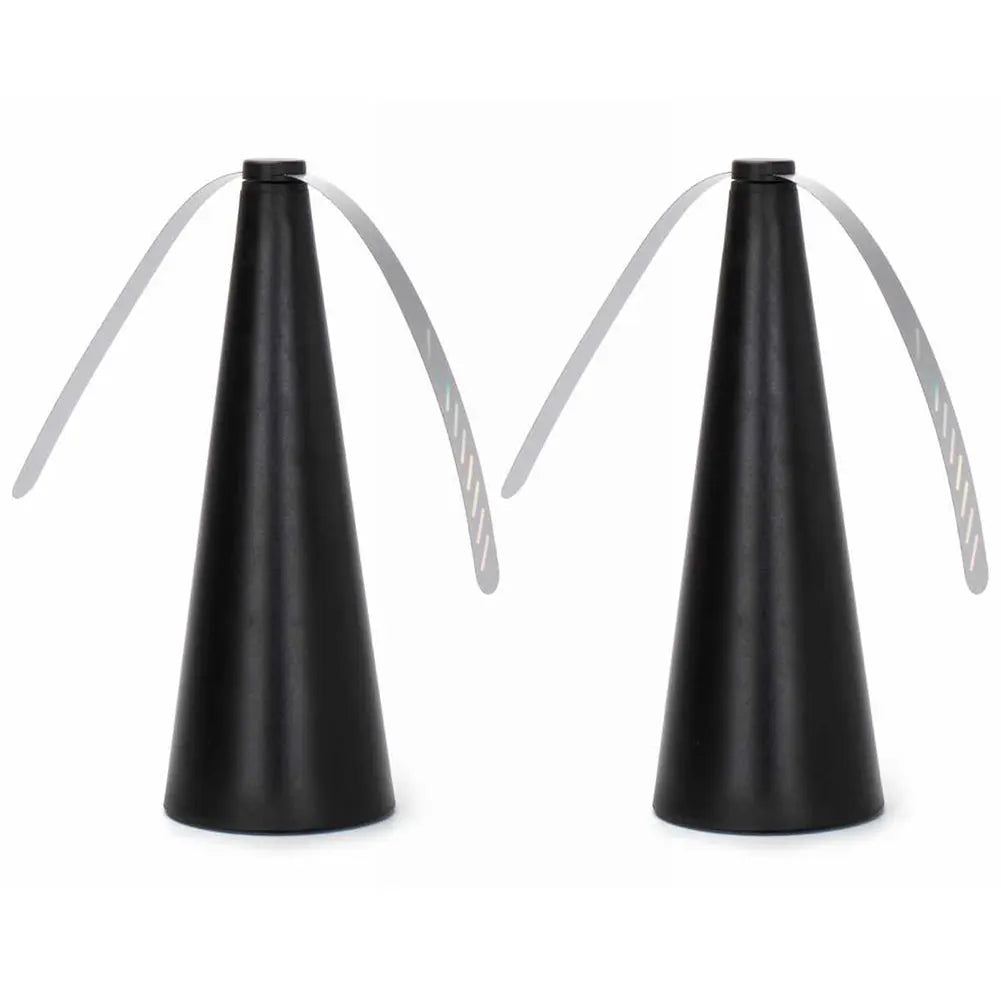 Two black cone-shaped objects with white strings on a white background