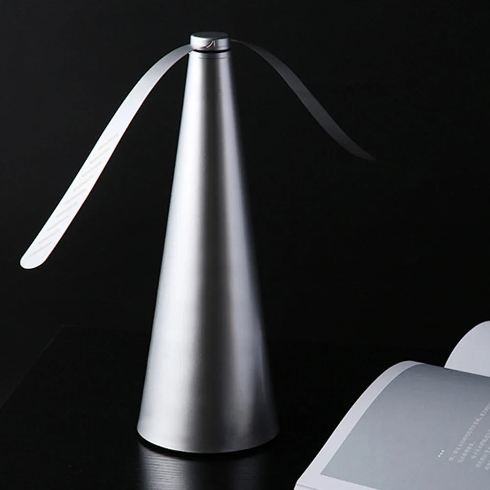 Modern silver table lamp with a black background