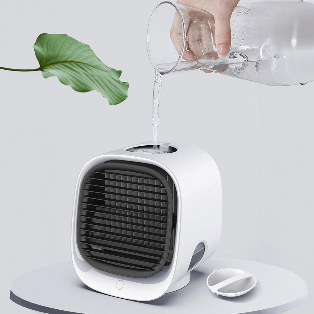 Small white fan with water being poured into it, next to a green leaf on a light gray background