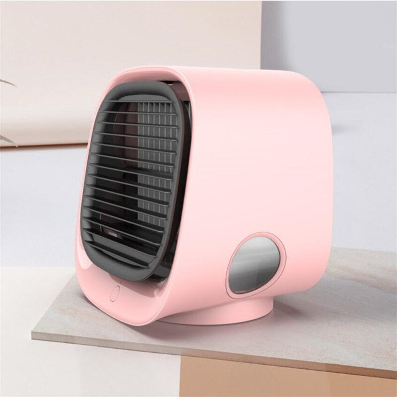 Pink portable fan on a light surface with a neutral background