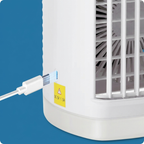 Small portable air conditioner with power cord on a blue background