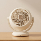 White fan on a wooden surface with a plain background