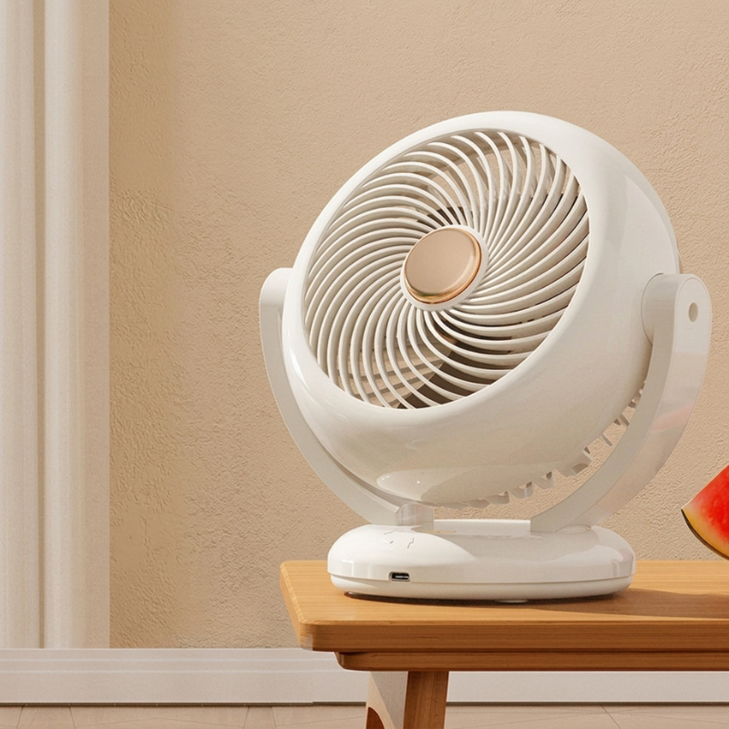 White table fan on a wooden surface with a beige wall background