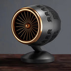 Decorative object resembling a jet engine on a wooden surface with a dark background