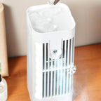 White portable fan on a wooden surface with a neutral background