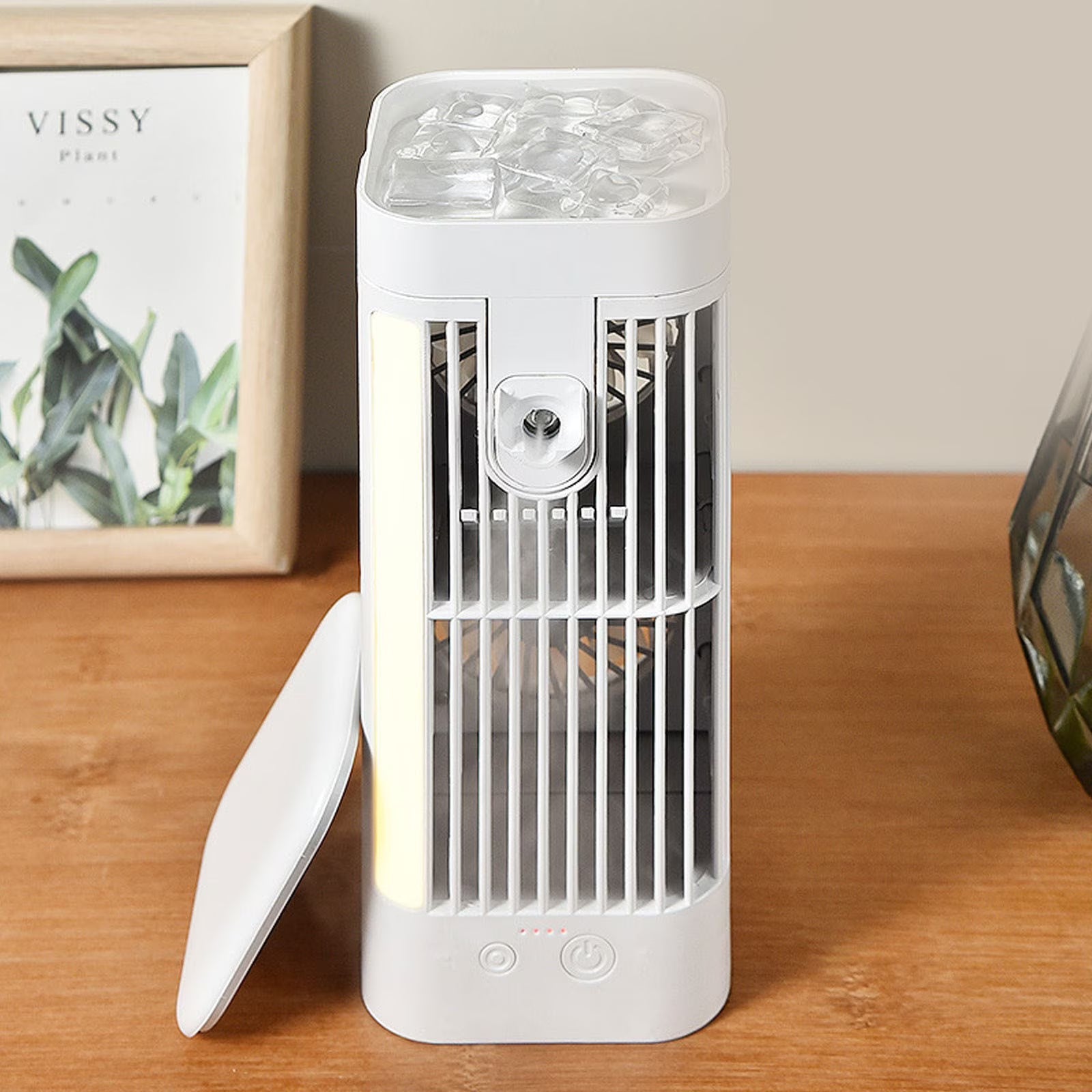 Portable fan with ice compartment on a wooden surface