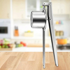 Metallic kitchen masher on a wooden surface with a blurred kitchen background