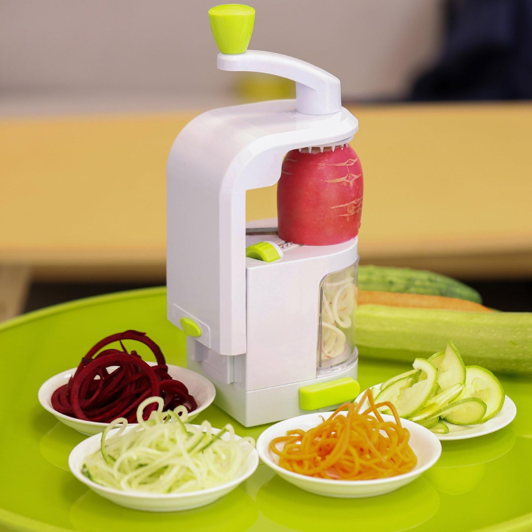Vegetable spiralizer with sliced vegetables on a green tray