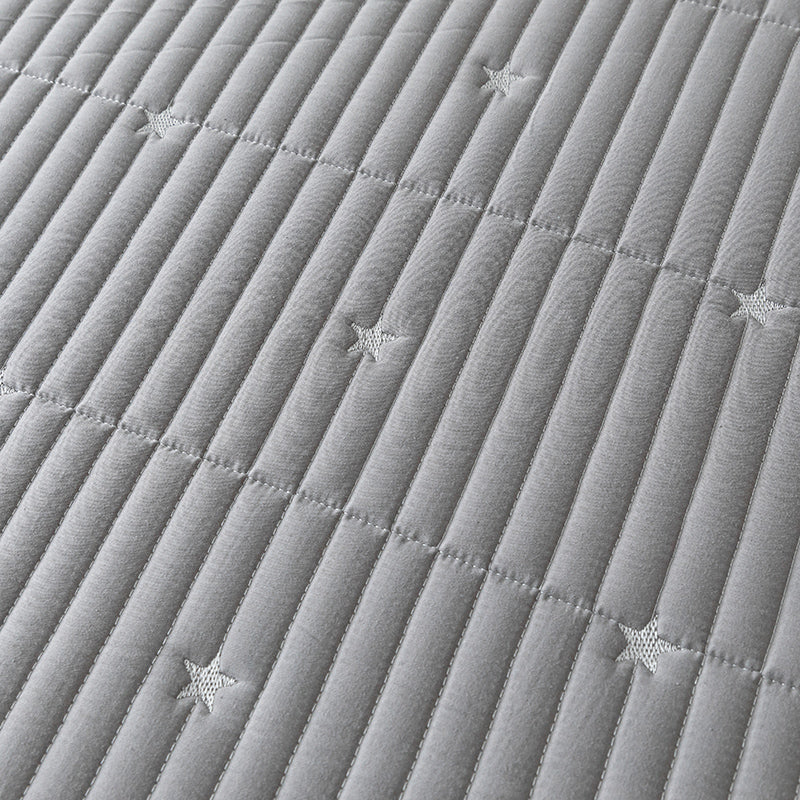 Close-up of a textured gray fabric with star patterns