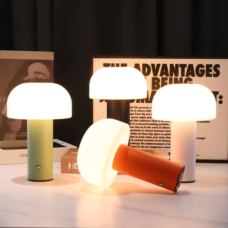 Set of colorful table lamps on a surface with a magazine in the background