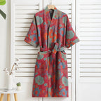 Colorful floral-patterned robe hanging against a white wooden panel background