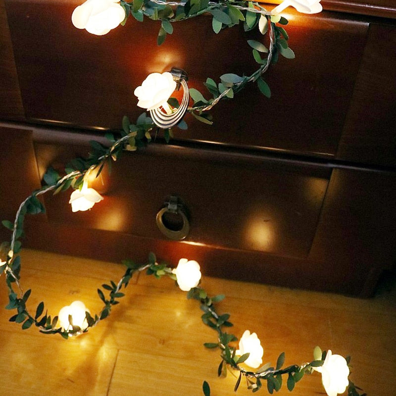 Decorative string lights with floral design on a wooden surface