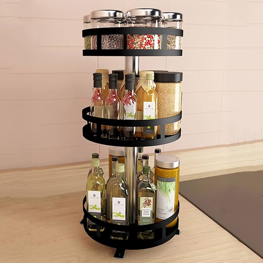 Rotating spice rack with various bottles and containers on a kitchen counter.