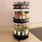 Rotating spice rack with various bottles and containers on a kitchen counter.