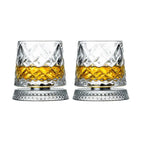 Two crystal glasses filled with amber liquid on a white background