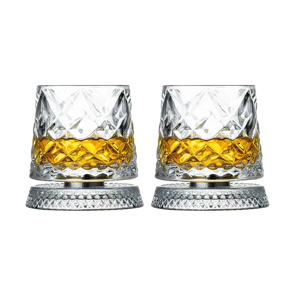 Two crystal glasses filled with amber liquid on a white background
