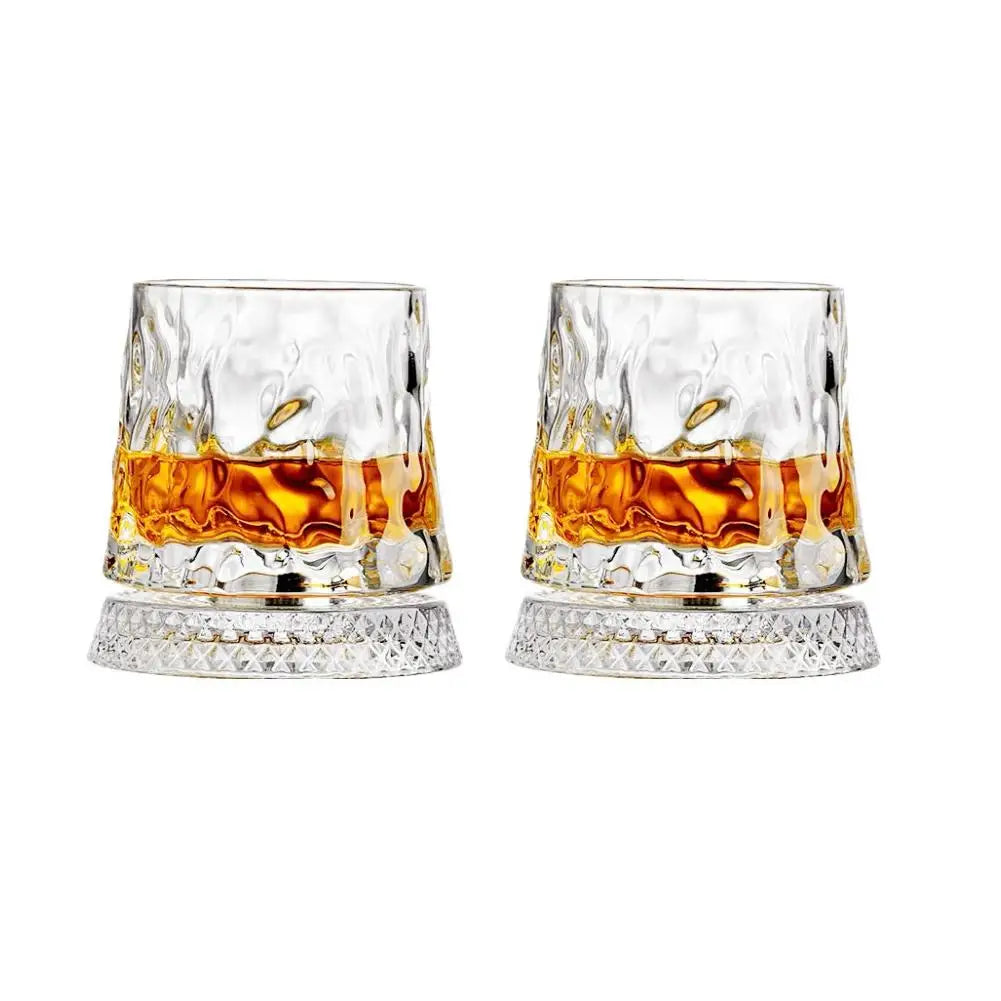 Two glasses of whiskey with a white background