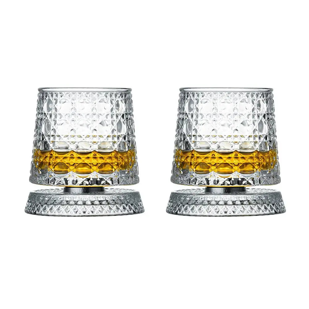 Two clear glass tumblers with textured design filled with a yellow liquid on a white background.