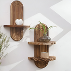 Two wooden wall shelves with decorative items on a white wall.