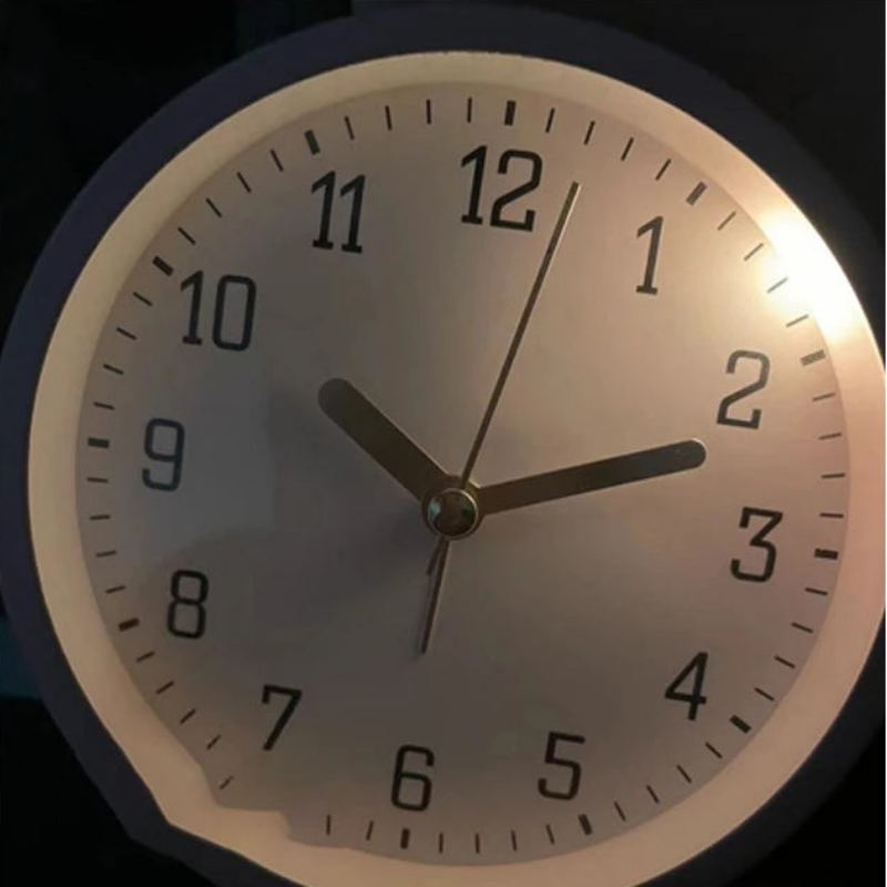 Wall clock with soft-light night light feature on a dark background