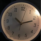 Wall clock with soft-light night light feature on a dark background