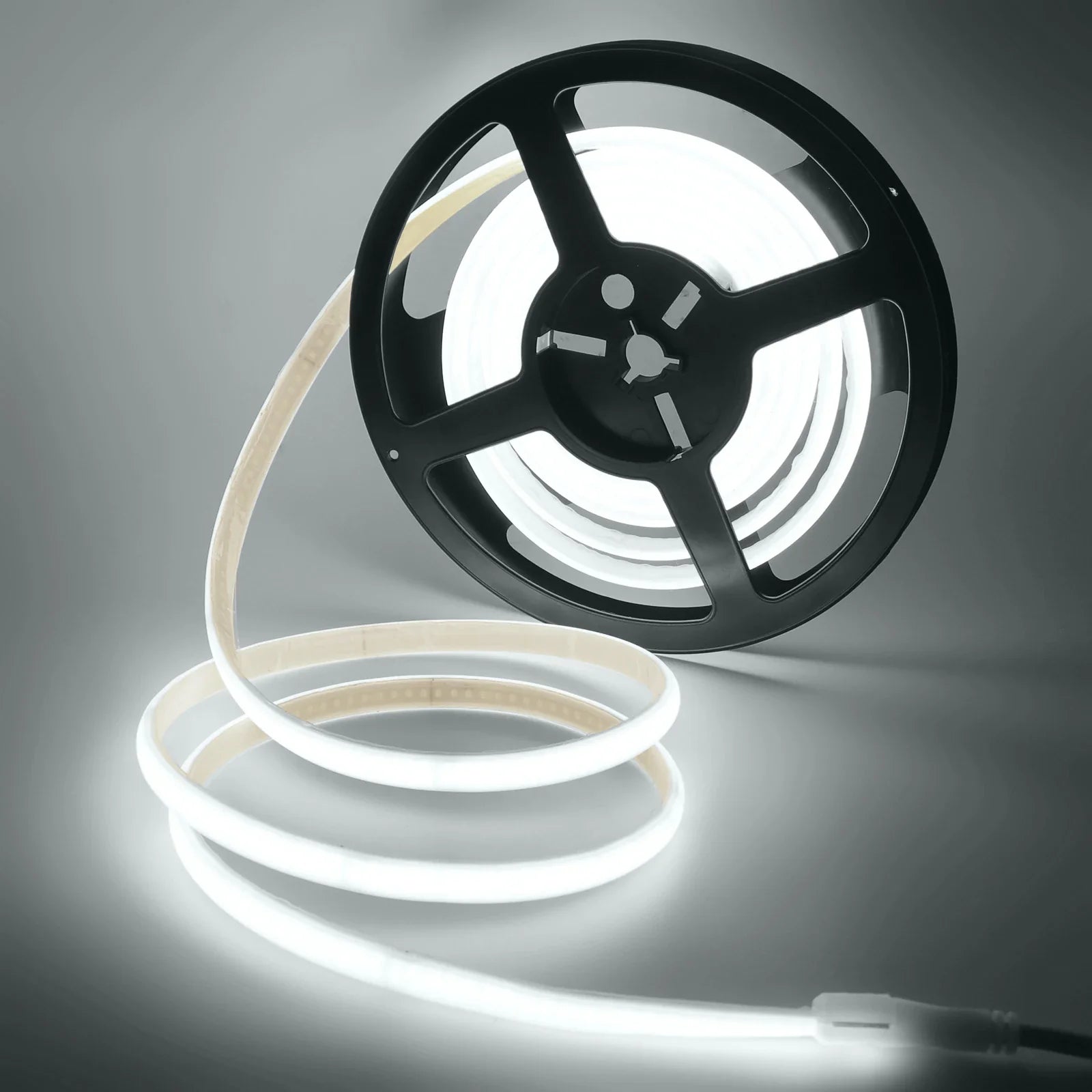 Spool of white LED strip light on a gray background